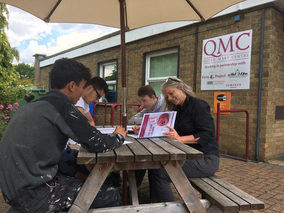 construction students collaborate with queen