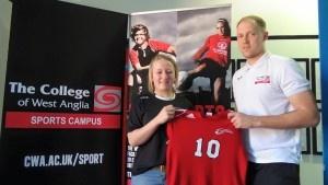 Dayna Kingshott with CWA Girls Elite Football Programme Head Coach Jamie Buhlemann holding Dayna new Owens Junior College shirt.