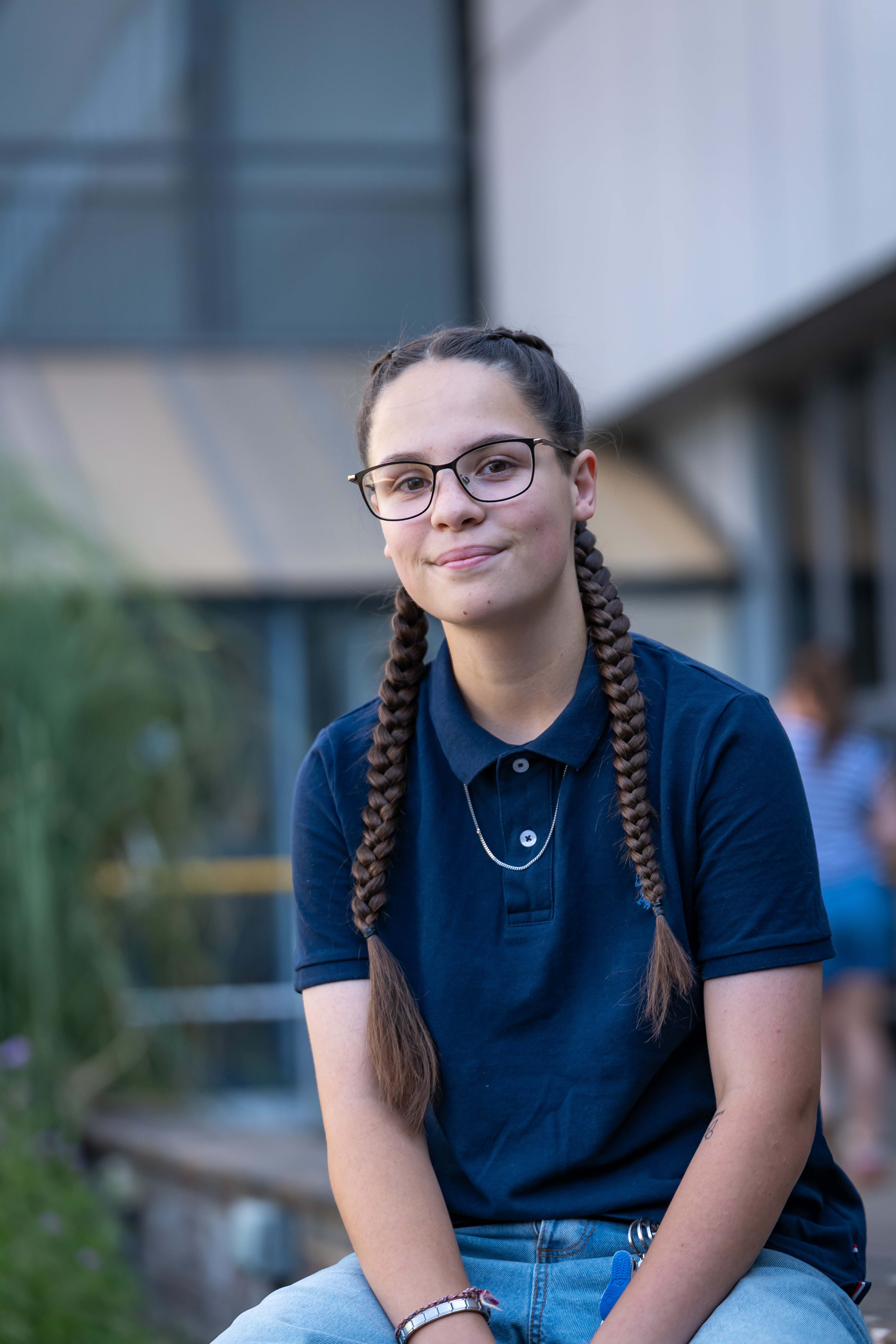 Student with french plaits smiling at camera