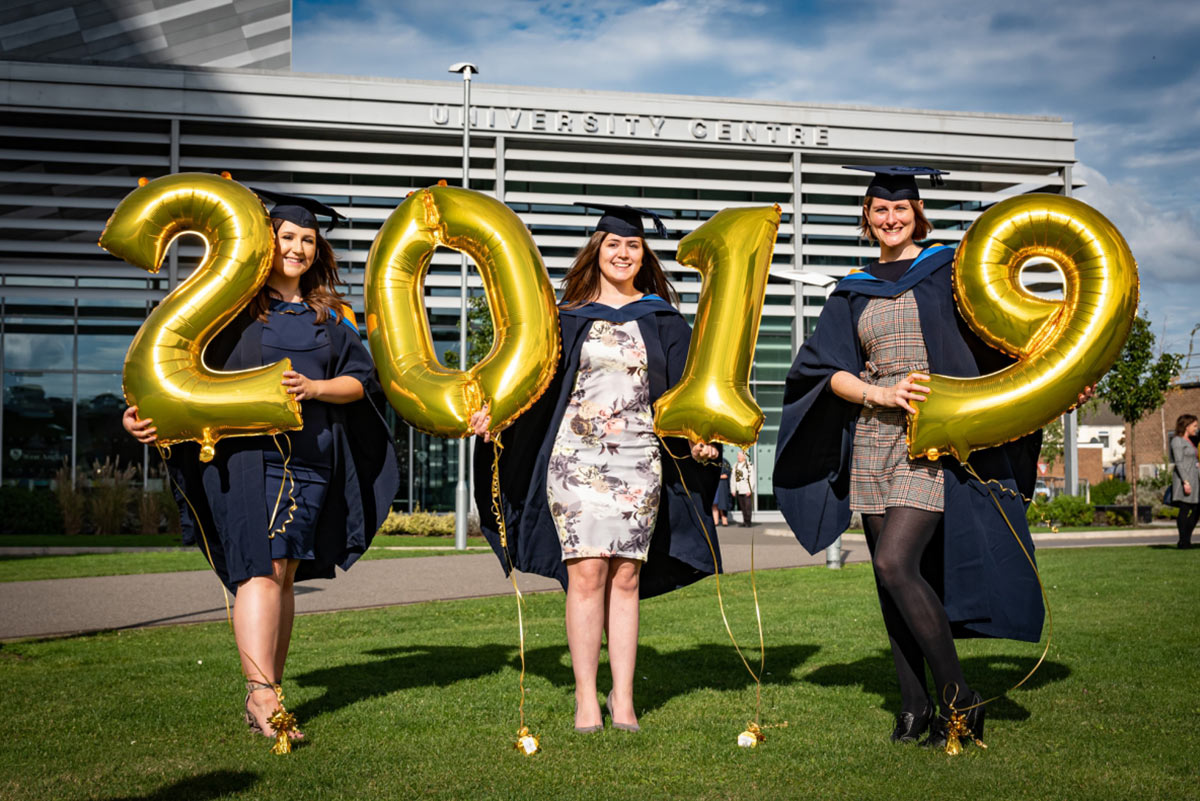 students celevrate at graduation